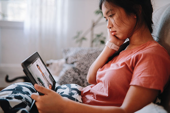 Asian woman scheduling virtual care